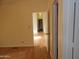 Bright hallway with wood-look floors, leading to other rooms at 30138 W Roosevelt St, Buckeye, AZ 85396