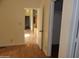 Light-filled hallway with wood floors, leading to other rooms at 30138 W Roosevelt St, Buckeye, AZ 85396