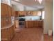 Kitchen with wood cabinets, stainless steel appliances, and laminate floor at 30138 W Roosevelt St, Buckeye, AZ 85396