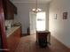 Kitchen features an island, door to backyard, and wood cabinets at 30138 W Roosevelt St, Buckeye, AZ 85396