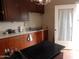 Galley kitchen with dark wood cabinets and a black countertop at 30138 W Roosevelt St, Buckeye, AZ 85396
