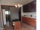 Bright kitchen features ample cabinetry, an island, and tile flooring at 30138 W Roosevelt St, Buckeye, AZ 85396