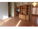 Living room with built-in wooden shelving and laminate floor at 30138 W Roosevelt St, Buckeye, AZ 85396