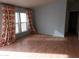 Bright living room with laminate flooring and large windows at 30138 W Roosevelt St, Buckeye, AZ 85396