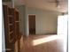 Living room with built-in shelving and wood-look floors at 30138 W Roosevelt St, Buckeye, AZ 85396