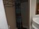 Shower stall with teal and brown patterned shower curtain at 30138 W Roosevelt St, Buckeye, AZ 85396