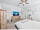 Bright bedroom with ceiling fan and built-in wooden dresser at 3111 N 309Th Dr, Buckeye, AZ 85396