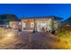 This backyard patio features a covered seating area, desert landscaping, and a fire pit at 4058 S Alamandas Way, Gold Canyon, AZ 85118