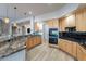 Spacious kitchen with granite countertops, stainless steel appliances, and light wood cabinets at 4058 S Alamandas Way, Gold Canyon, AZ 85118