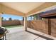 Covered patio with artificial turf and block wall at 45513 W Sky Ln, Maricopa, AZ 85139