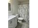 Bathroom with white vanity, shower/tub combo, and gray floor at 5839 E Norwood St, Mesa, AZ 85215