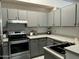 Modern kitchen with stainless steel appliances and gray cabinets at 5839 E Norwood St, Mesa, AZ 85215