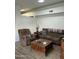 Living room with brown recliner, sofa, and wooden coffee table at 5839 E Norwood St, Mesa, AZ 85215