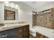 Bathroom with a bathtub, patterned tile and dark vanity at 6031 E Kohuana Pl, Cave Creek, AZ 85331