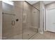 Large walk-in shower with glass enclosure and built-in seat at 6530 E Libby St, Phoenix, AZ 85054