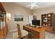 Bright home office features built-in shelving and hardwood floors at 823 E Dragon Springs Dr, Casa Grande, AZ 85122