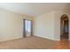 Living room featuring carpet, neutral walls, and hallway access at 8346 W Marlette Ave, Glendale, AZ 85305