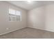 Simple bedroom with window and neutral wall colors at 8924 W Mackenzie Dr, Phoenix, AZ 85037