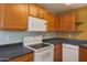 Kitchen features wood cabinets, and modern appliances at 930 N Mesa Dr # 2034, Mesa, AZ 85201