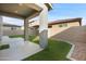 Artificial turf backyard with covered patio at 9814 E Palladium Dr, Mesa, AZ 85212