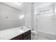 Clean bathroom with a tub, shower, and dark vanity at 9814 E Palladium Dr, Mesa, AZ 85212