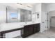 Double vanity bathroom with a large mirror and walk-in shower at 9814 E Palladium Dr, Mesa, AZ 85212