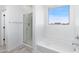 Bathroom features a shower and bathtub with window at 9814 E Palladium Dr, Mesa, AZ 85212