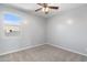 Well-lit bedroom featuring carpet and a ceiling fan at 9814 E Palladium Dr, Mesa, AZ 85212