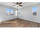 Bedroom with wood-look floors and multiple windows at 9814 E Palladium Dr, Mesa, AZ 85212