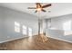 Bright bedroom with wood-look floors and ceiling fan at 9814 E Palladium Dr, Mesa, AZ 85212