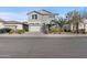 Two-story house with gray siding, two-car garage, and landscaping at 9814 E Palladium Dr, Mesa, AZ 85212