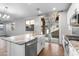 Kitchen island with granite countertop, farmhouse sink, and backyard access at 9814 E Palladium Dr, Mesa, AZ 85212