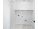 Laundry room with built-in shelving and flooring at 9814 E Palladium Dr, Mesa, AZ 85212