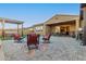 Landscaped backyard with hot tub, pergola, and fire pit at 10220 E Thatcher Ave, Mesa, AZ 85212