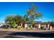 House exterior showcasing a wide street and mature trees surrounding the property at 10601 N 26Th Pl, Phoenix, AZ 85028