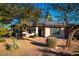 House exterior with a brick pathway, solar panels, and landscaping at 10601 N 26Th Pl, Phoenix, AZ 85028