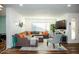 Bright living room featuring L-shaped sectional sofa and large TV at 10601 N 26Th Pl, Phoenix, AZ 85028