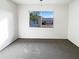 Simple bedroom with gray carpet and a large window at 11003 N 48Th Ave, Glendale, AZ 85304