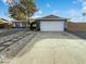 Ranch style home with a two-car garage and landscaped front yard at 11003 N 48Th Ave, Glendale, AZ 85304