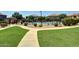 Community pool with lounge chairs and grassy area at 1265 S Aaron -- # 359, Mesa, AZ 85209