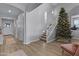 Bright entryway with wood-look floors, and view of staircase at 22911 E Thornton Rd, Queen Creek, AZ 85142