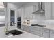 Modern kitchen with white cabinets, quartz countertops, and stainless steel appliances at 22911 E Thornton Rd, Queen Creek, AZ 85142