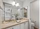 Double vanity bathroom with granite countertop and large mirror at 4020 N 151St Dr, Goodyear, AZ 85395