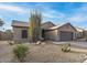 Charming desert landscape with a single-story home and gravel driveway at 4020 N 151St Dr, Goodyear, AZ 85395