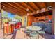 Rustic outdoor bar with seating and fun decor at 41525 E Desert Dove Dr, Marana, AZ 85658