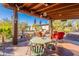 Covered patio with seating area and desert landscaping views at 41525 E Desert Dove Dr, Marana, AZ 85658