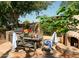 Outdoor patio with seating, built-in grill, and fireplace at 4528 E Hobart St, Mesa, AZ 85205