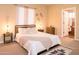 Bright bedroom with a queen-size bed and ensuite bathroom at 4528 E Hobart St, Mesa, AZ 85205