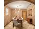 Formal dining room with a rustic wooden table and modern light fixture at 4528 E Hobart St, Mesa, AZ 85205