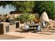 Outdoor kitchen and dining area with built-in grill at 4528 E Hobart St, Mesa, AZ 85205